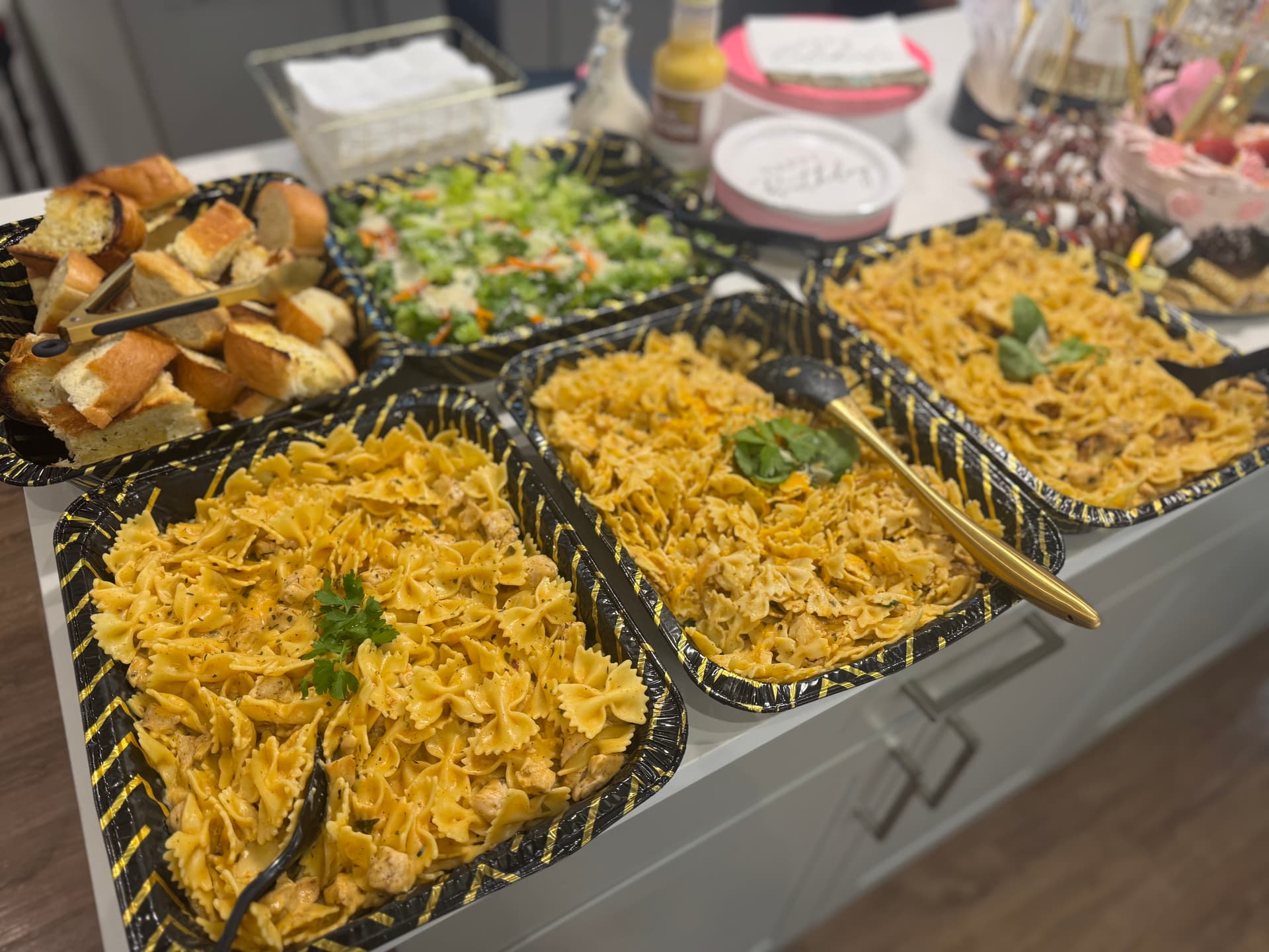 Full catering spread with pasta and fresh ingredients